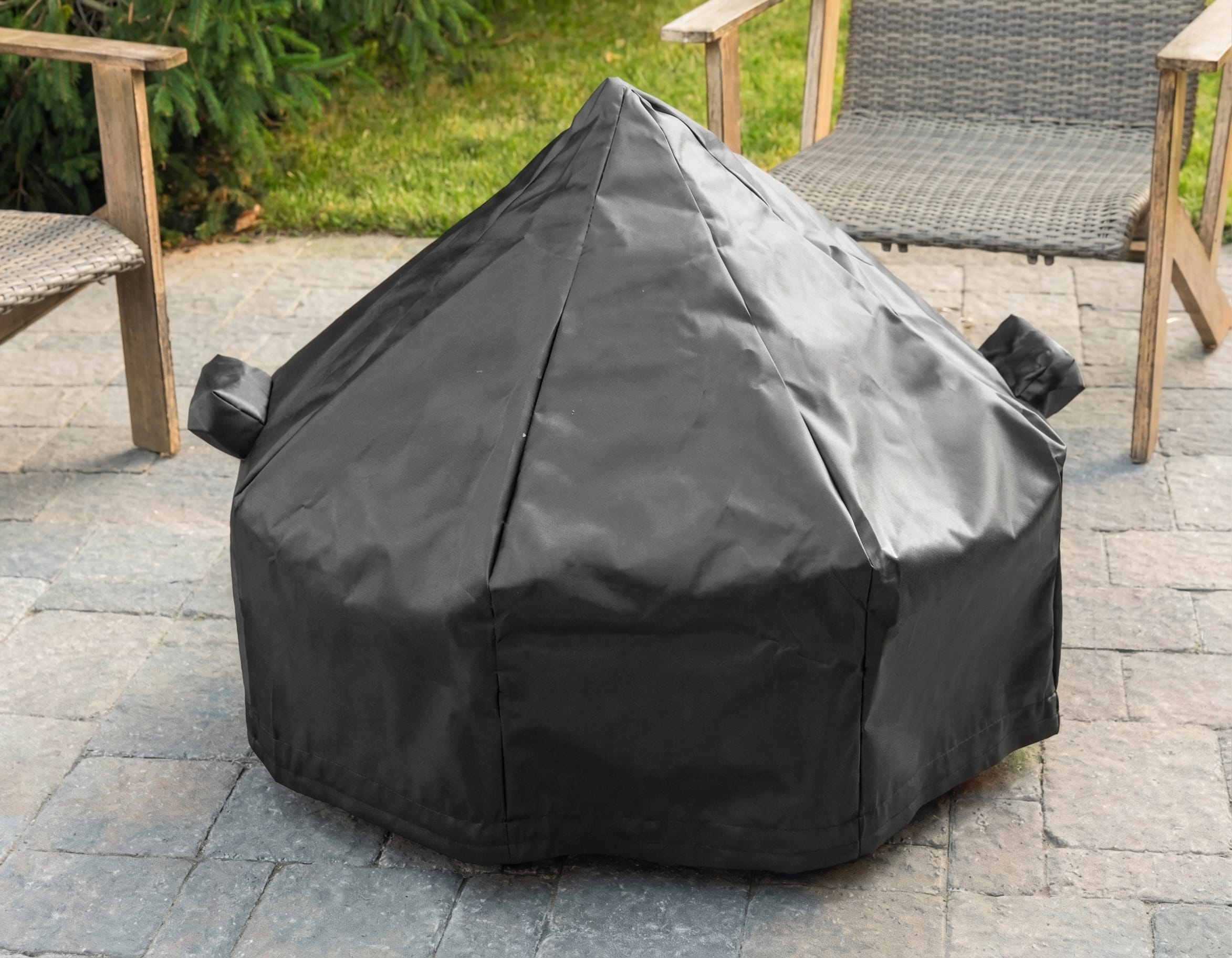 Tarp cover protecting a fire pit outdoors