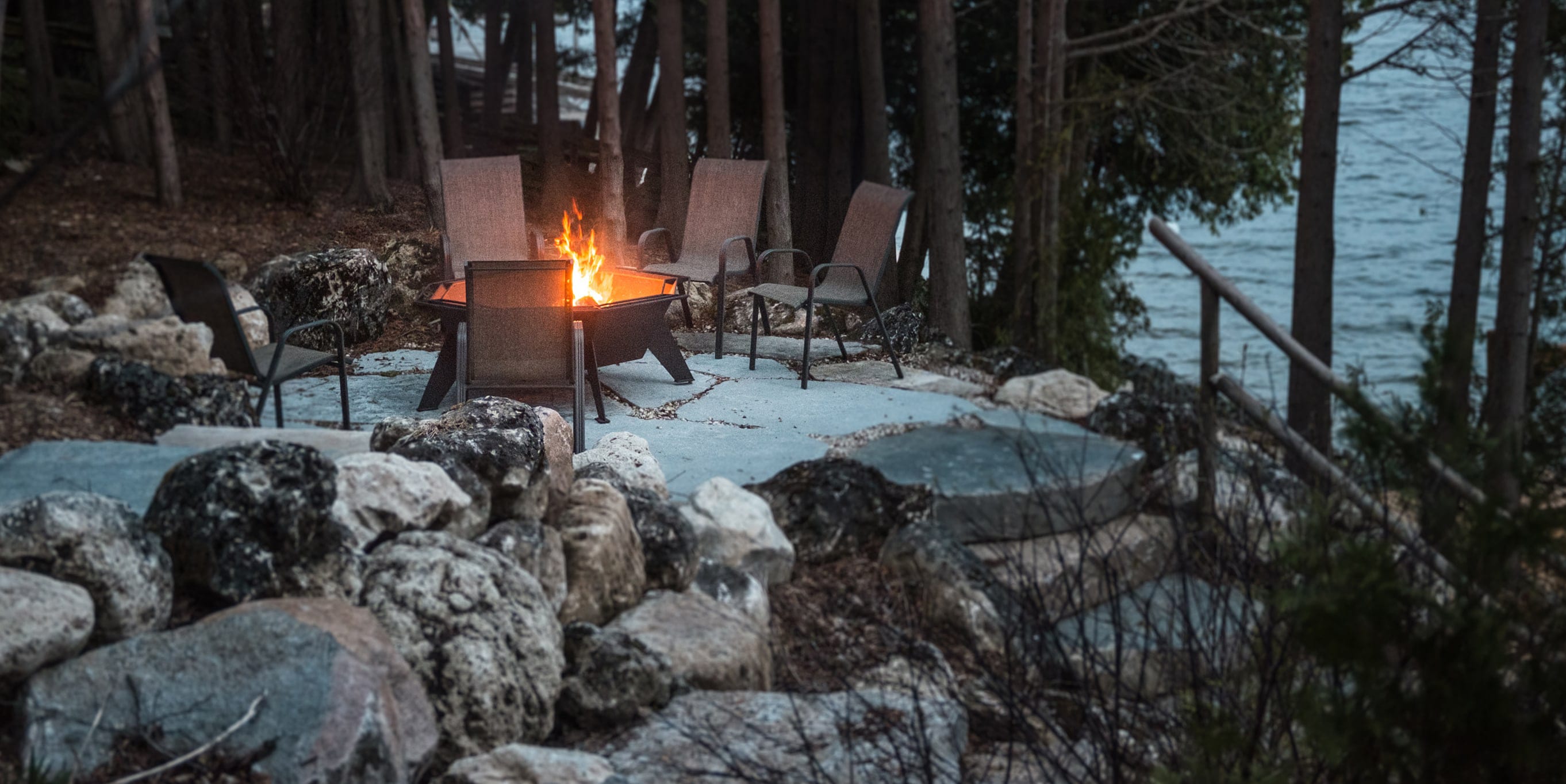 Iron Embers chiminea fireplace lit outdoors at dusk.