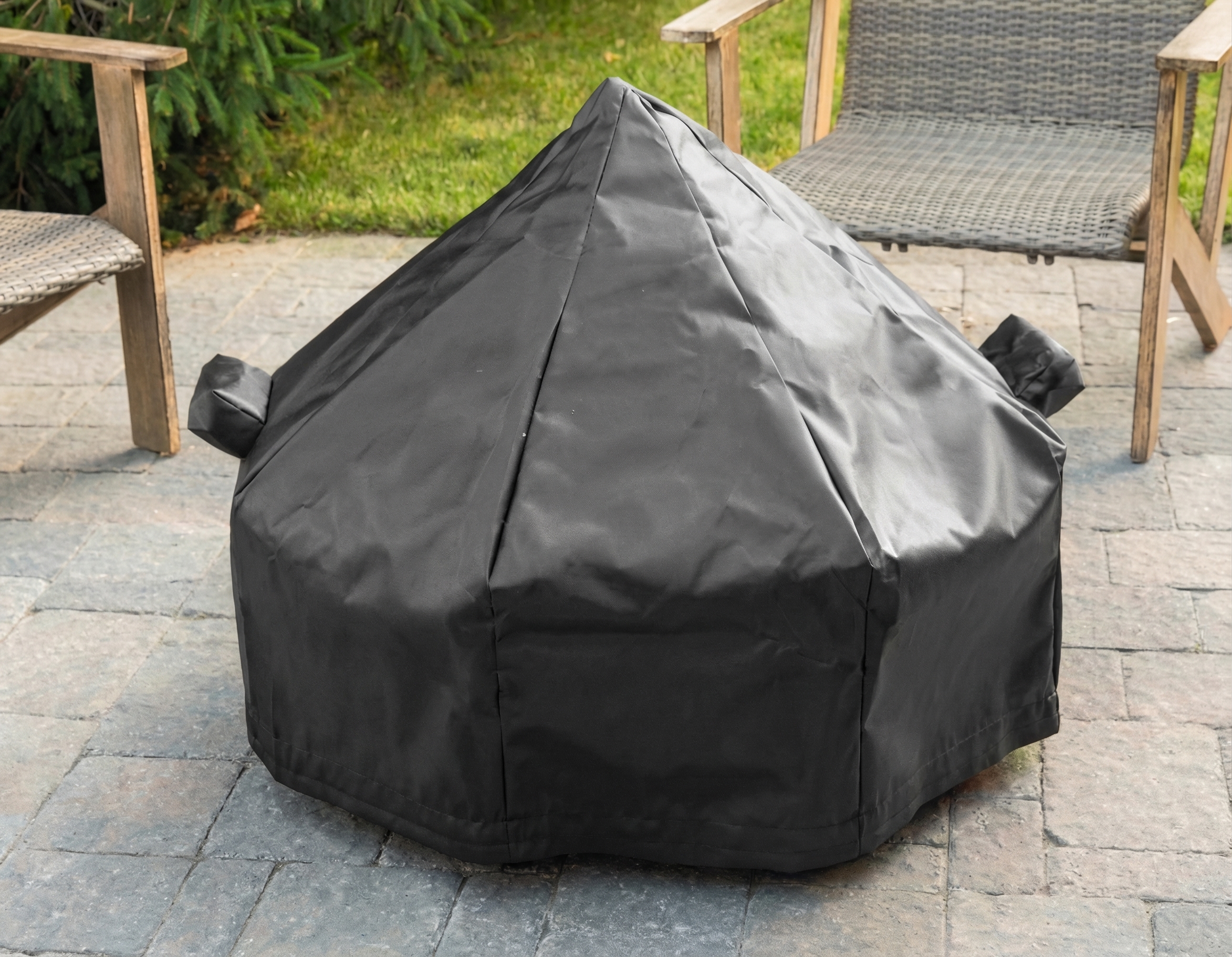 Tarp cover protecting a fire pit outdoors